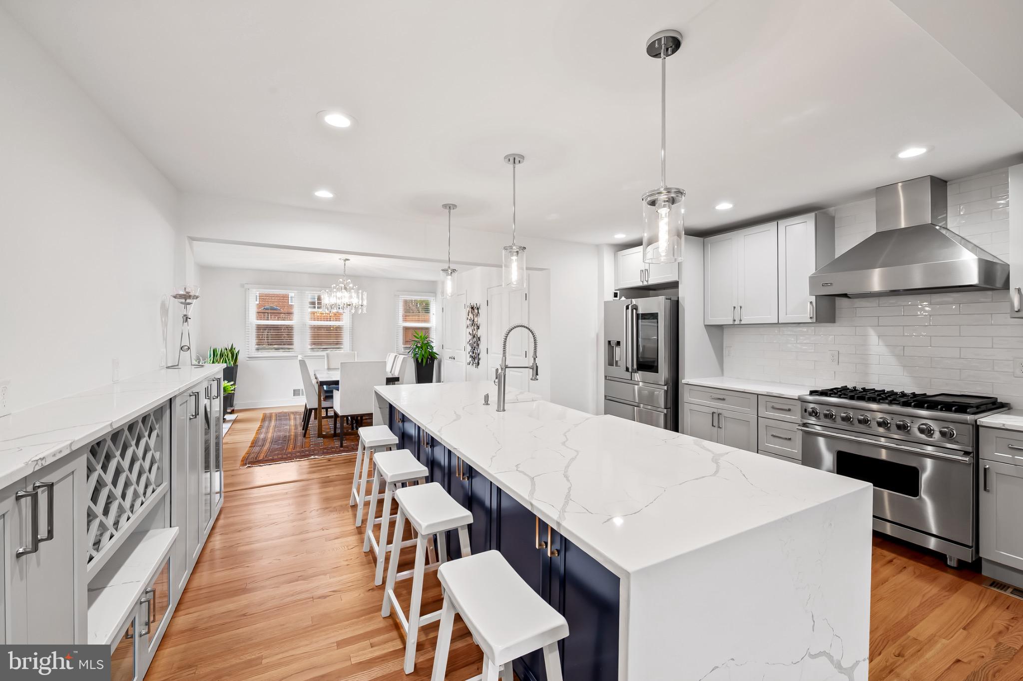 312 Waveland Road Catonsville, MD 21228 - Photo 14 of 40 a open kitchen with stainless steel appliances granite countertop a stove a refrigerator a kitchen island a sink and a wooden floors