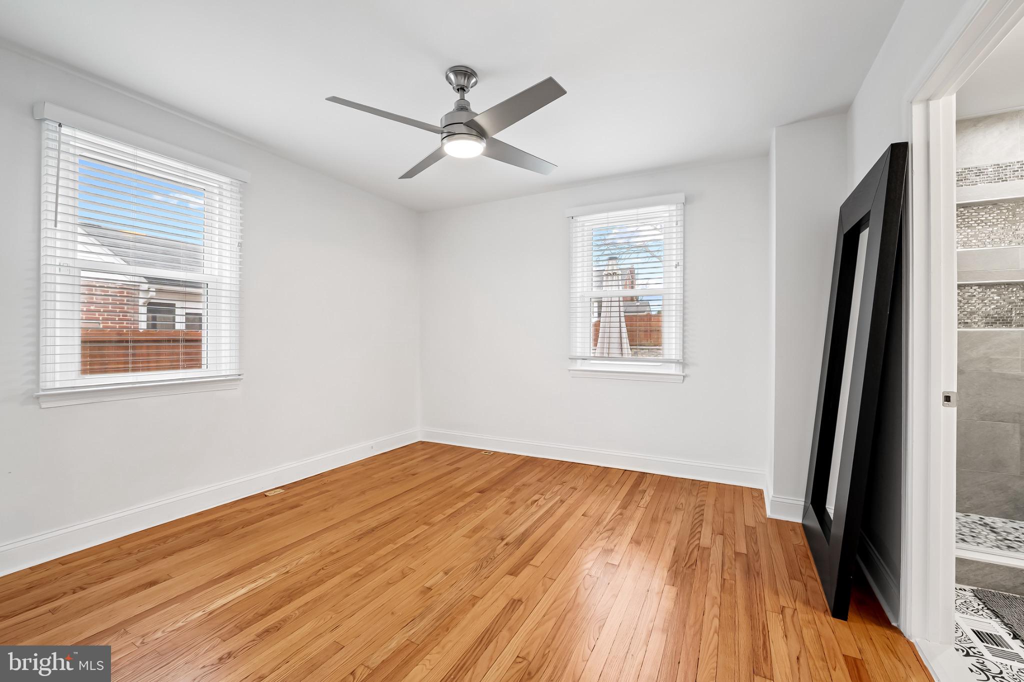 312 Waveland Road Catonsville, MD 21228 - Photo 19 of 40 a view of empty room with wooden floor and fan