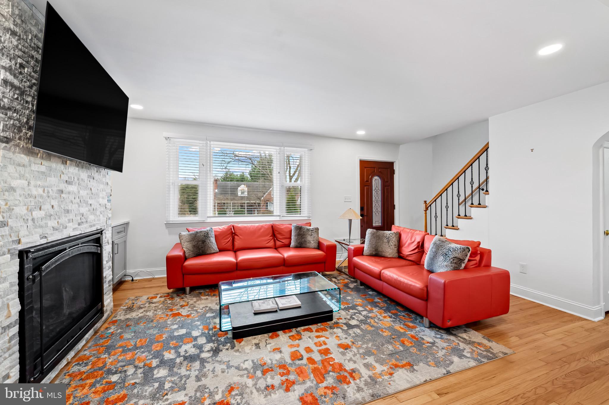 312 Waveland Road Catonsville, MD 21228 - Photo 5 of 40 a living room with furniture a flat screen tv and a fireplace