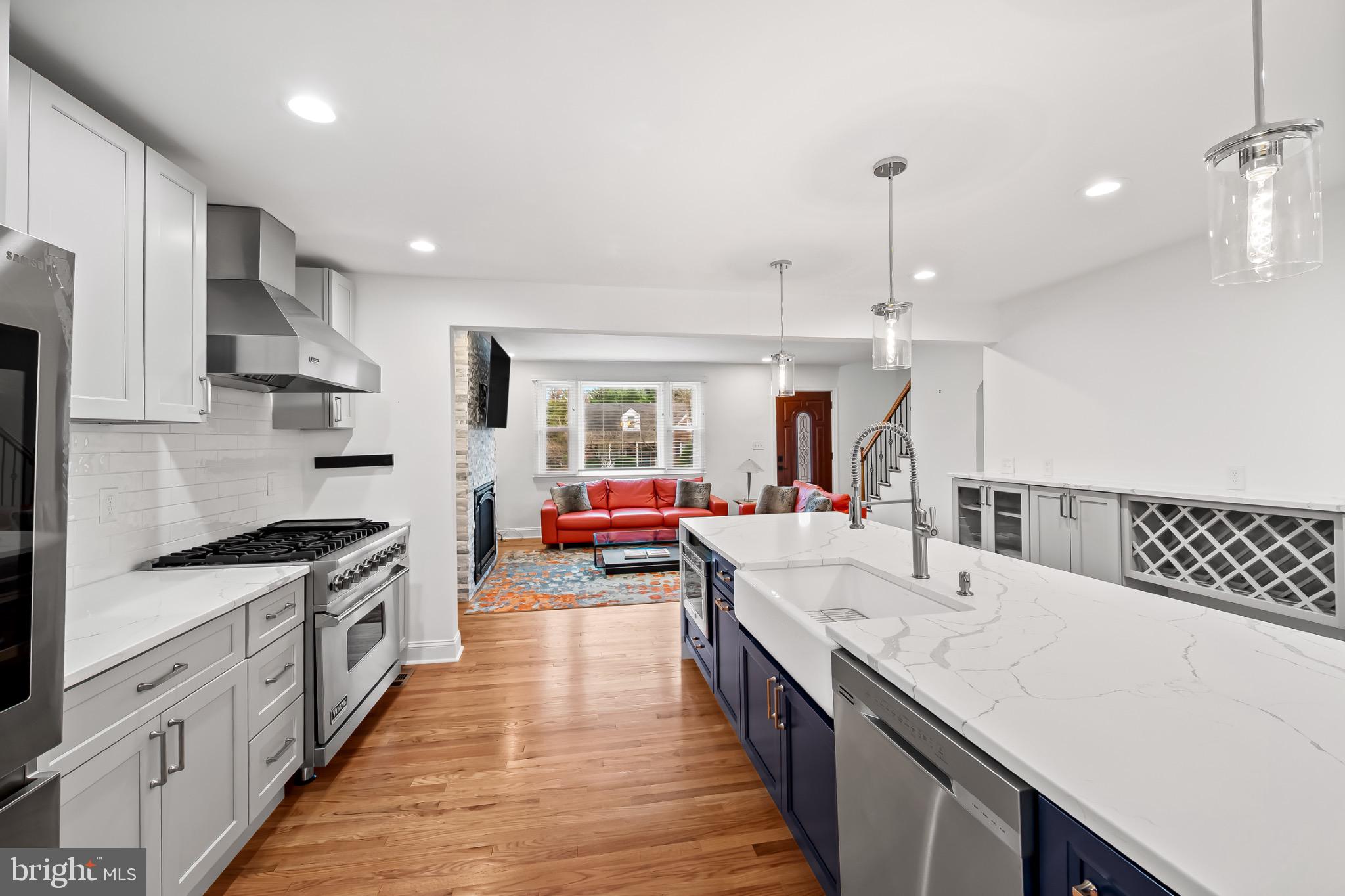 312 Waveland Road Catonsville, MD 21228 - Photo 10 of 40 a large kitchen with stainless steel appliances kitchen island granite countertop a lot of counter space and wooden floors