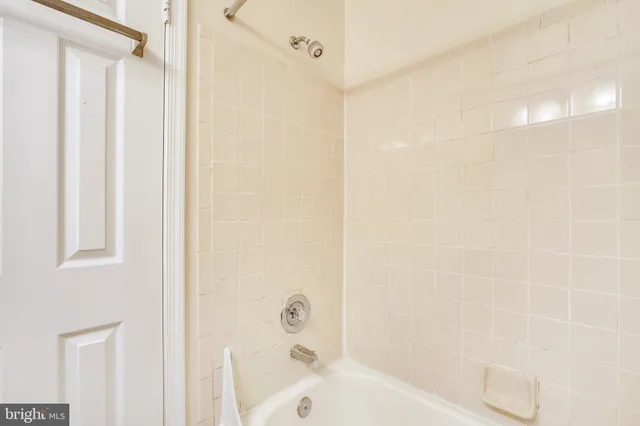 a bathroom with a bathtub and shower