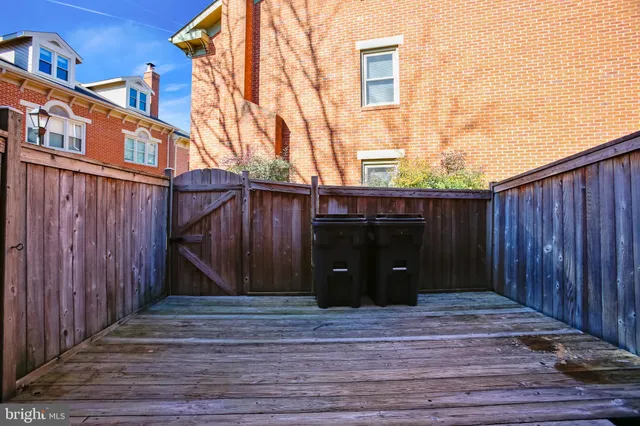 a view of a house with a wooden fence