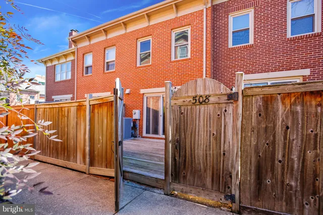 a front view of a house with wooden fence