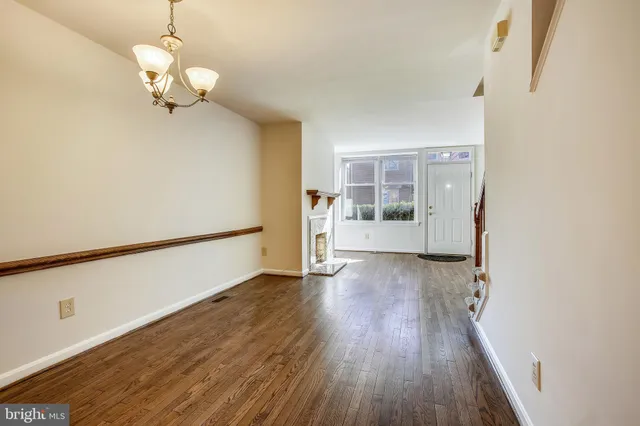 a view of a kitchen with wooden floor and a refrigerator