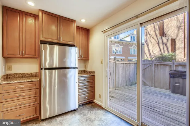 a view of kitchen with wooden floor and electronic appliances