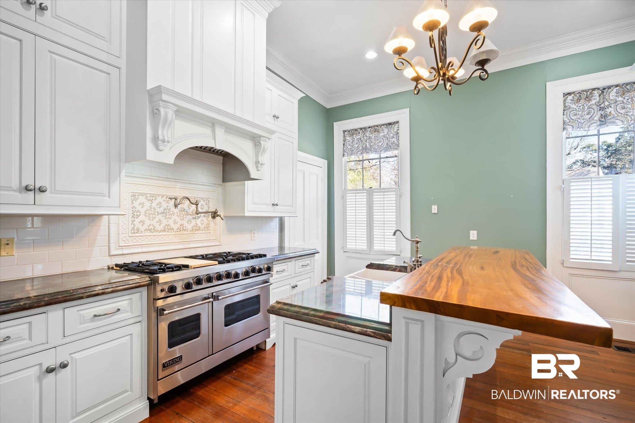 950 Palmetto Street Mobile, AL 36604 - Photo 8 of 33 Kitchen with butcher block counters, sink, white cabinets, double oven range, and a kitchen island with sink