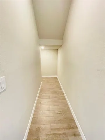 a view of hallway with wooden floor