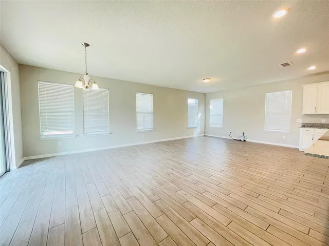 a view of a room with wooden floor and window