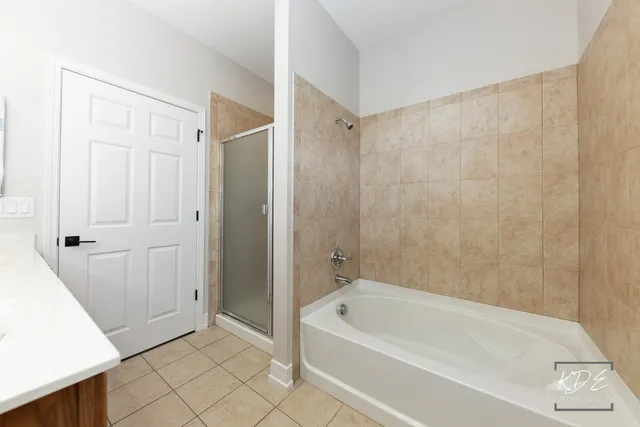 a bathroom with a bathtub and shower