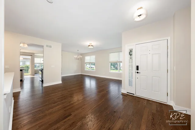 a view of an empty room and wooden floor
