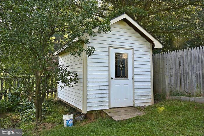 6716 Garrett Road Derwood, MD 20855 - Photo 28 of 30 a view of a house with a yard