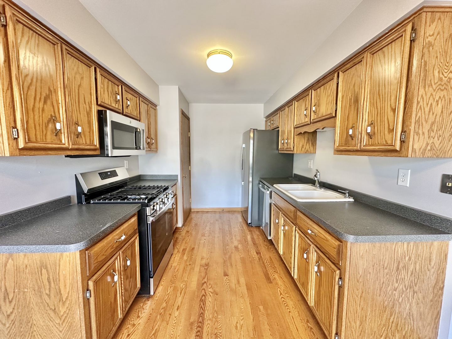 762 Lake Road New Lenox, IL 60451 - Photo 5 of 24 a kitchen with stainless steel appliances granite countertop a stove and a sink