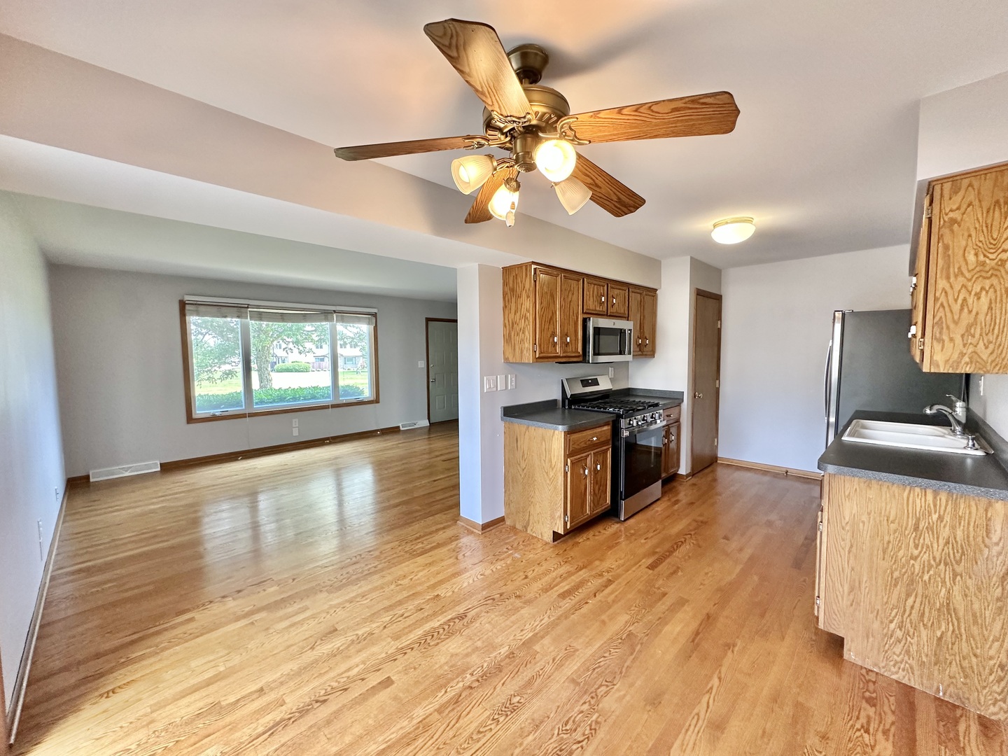 762 Lake Road New Lenox, IL 60451 - Photo 6 of 24 a kitchen with kitchen island a counter top space appliances and a ceiling fan