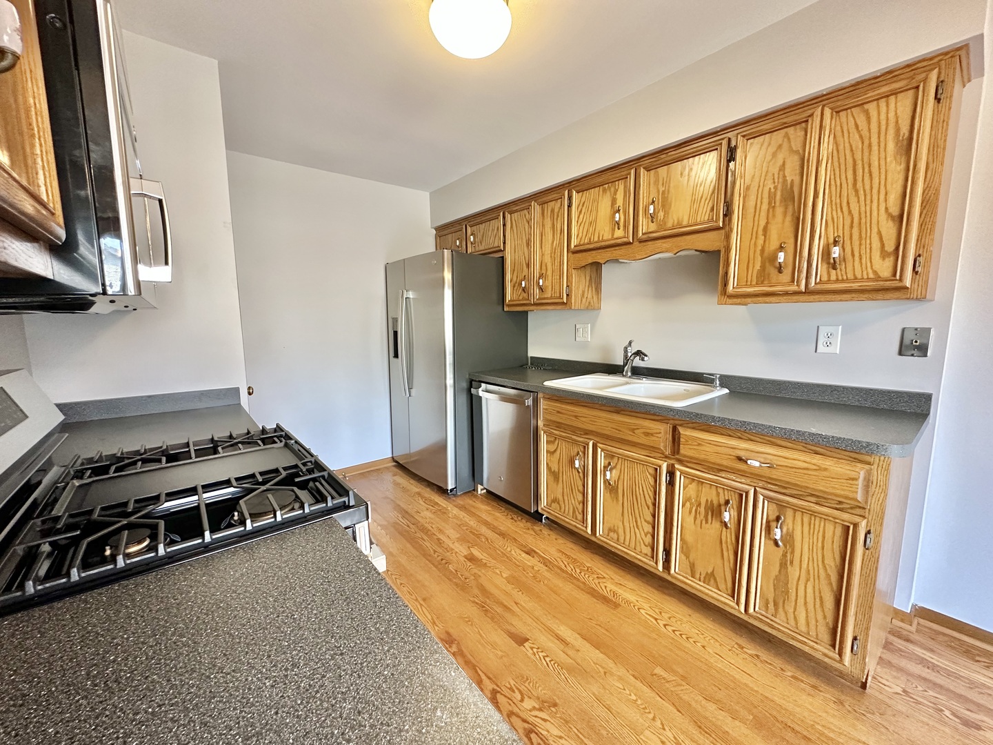 762 Lake Road New Lenox, IL 60451 - Photo 8 of 24 a kitchen with stainless steel appliances granite countertop a sink stove and refrigerator