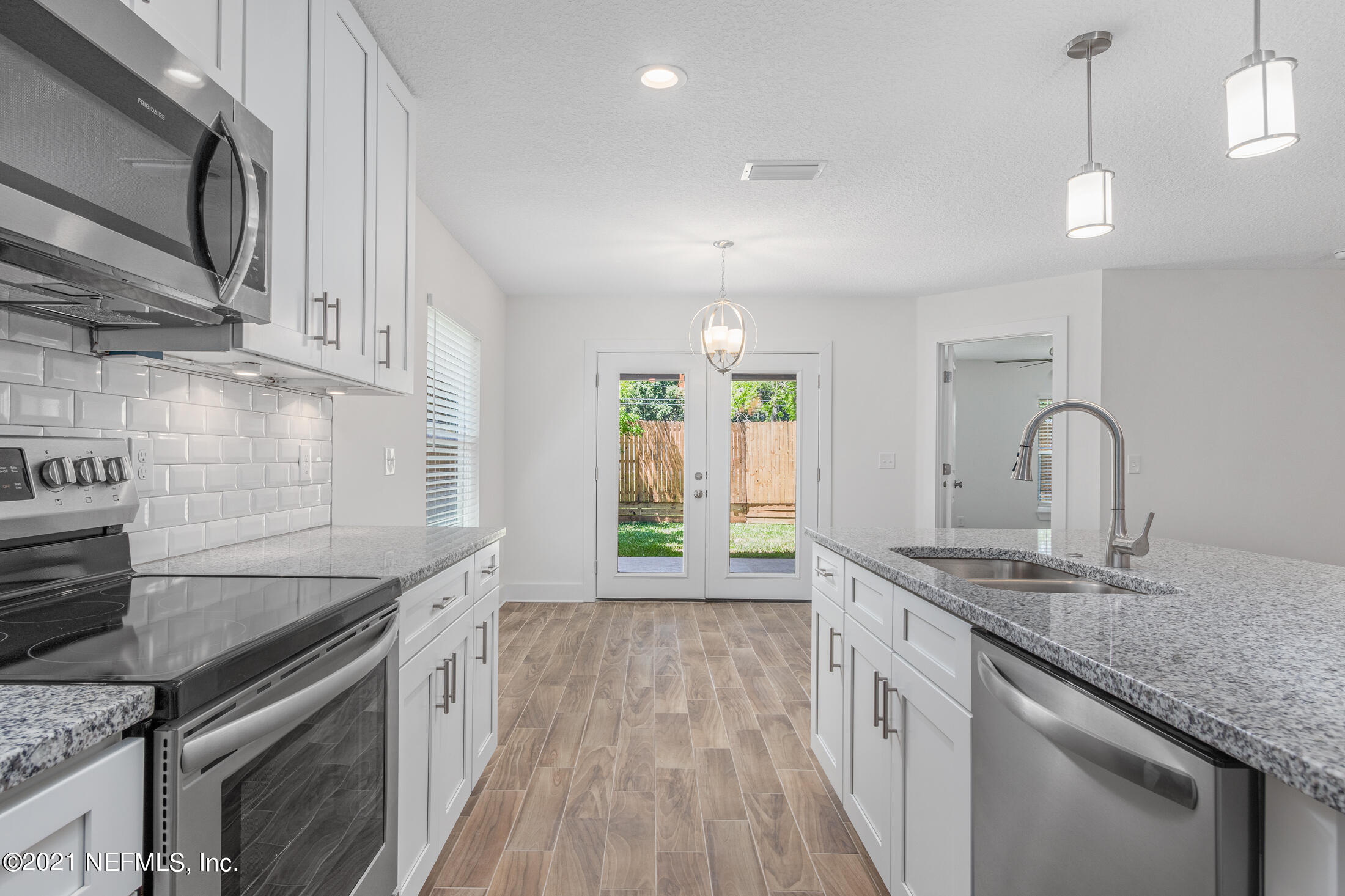 528 Meteor Street Jacksonville, FL 32205 - Photo 11 of 34 a kitchen with granite countertop a sink stainless steel appliances and cabinets