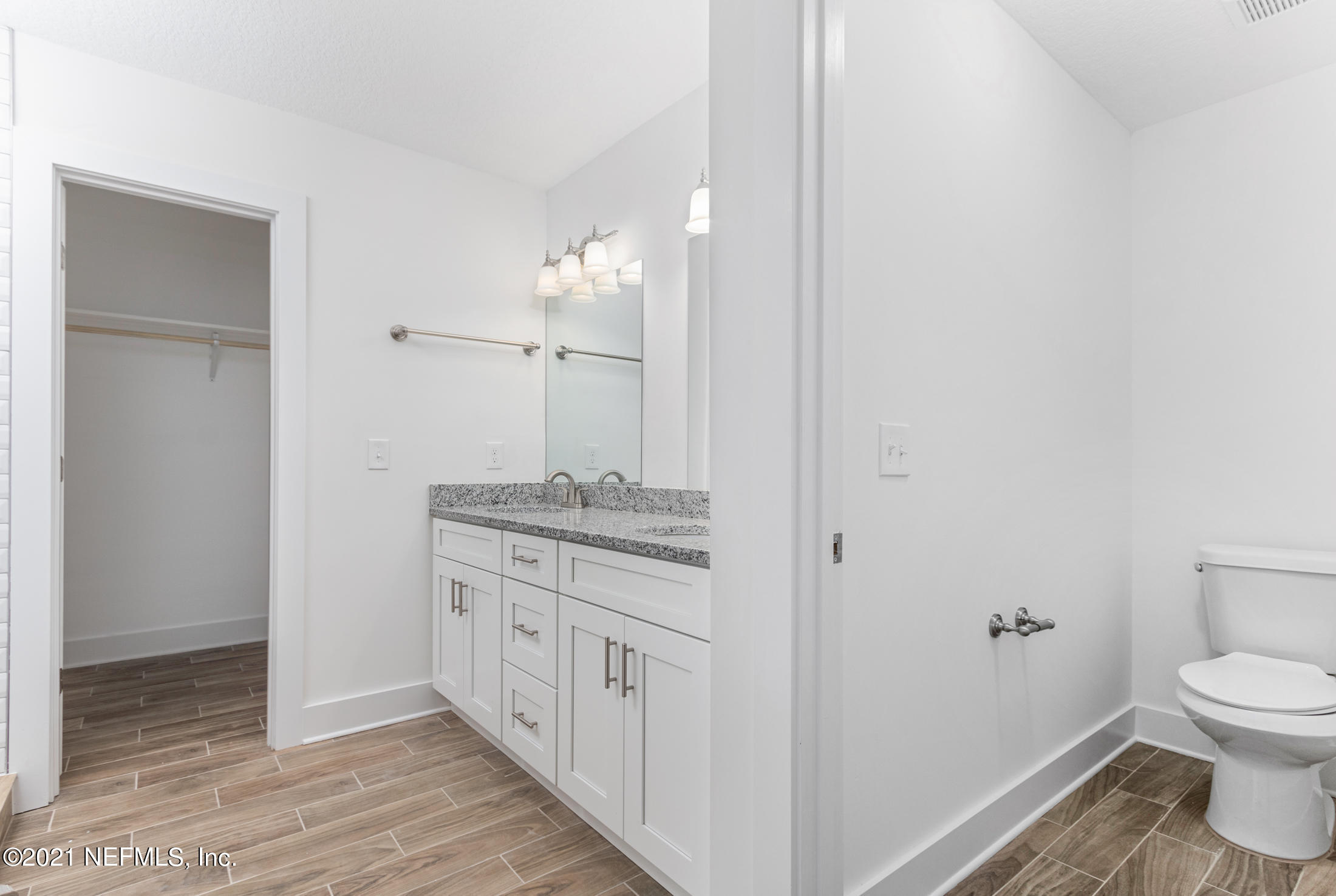 528 Meteor Street Jacksonville, FL 32205 - Photo 15 of 34 a bathroom with a granite countertop sink a toilet and a mirror