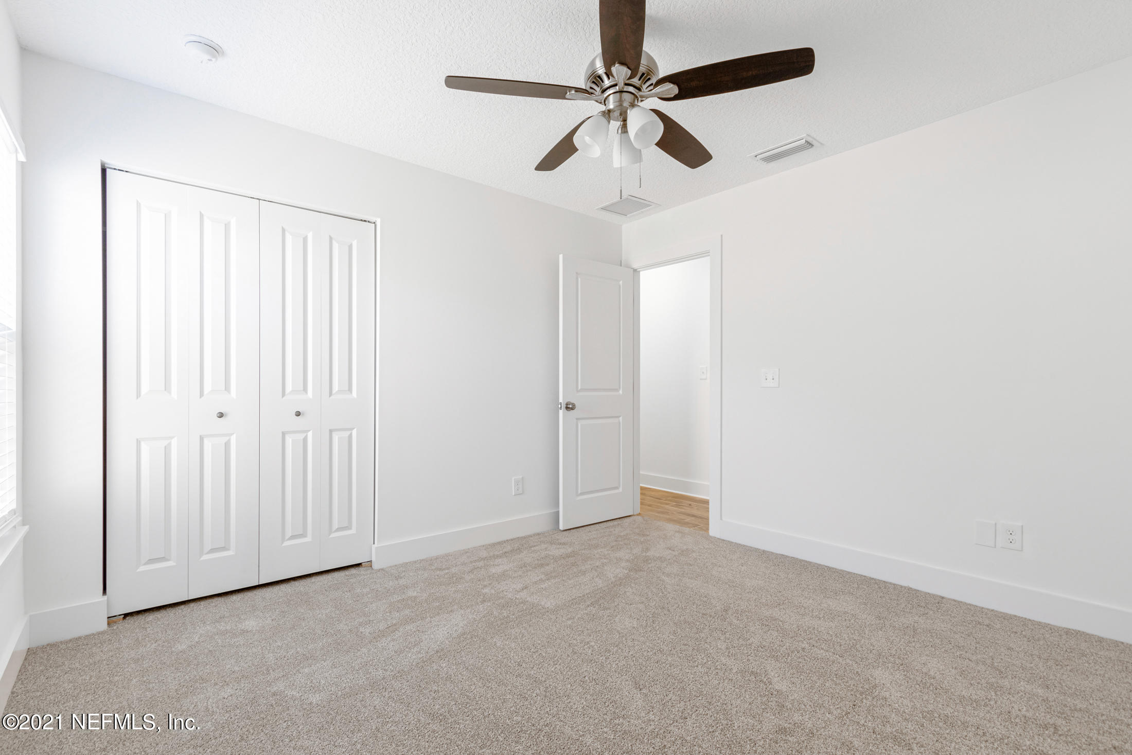 528 Meteor Street Jacksonville, FL 32205 - Photo 21 of 34 an empty room with a ceiling fan and a window