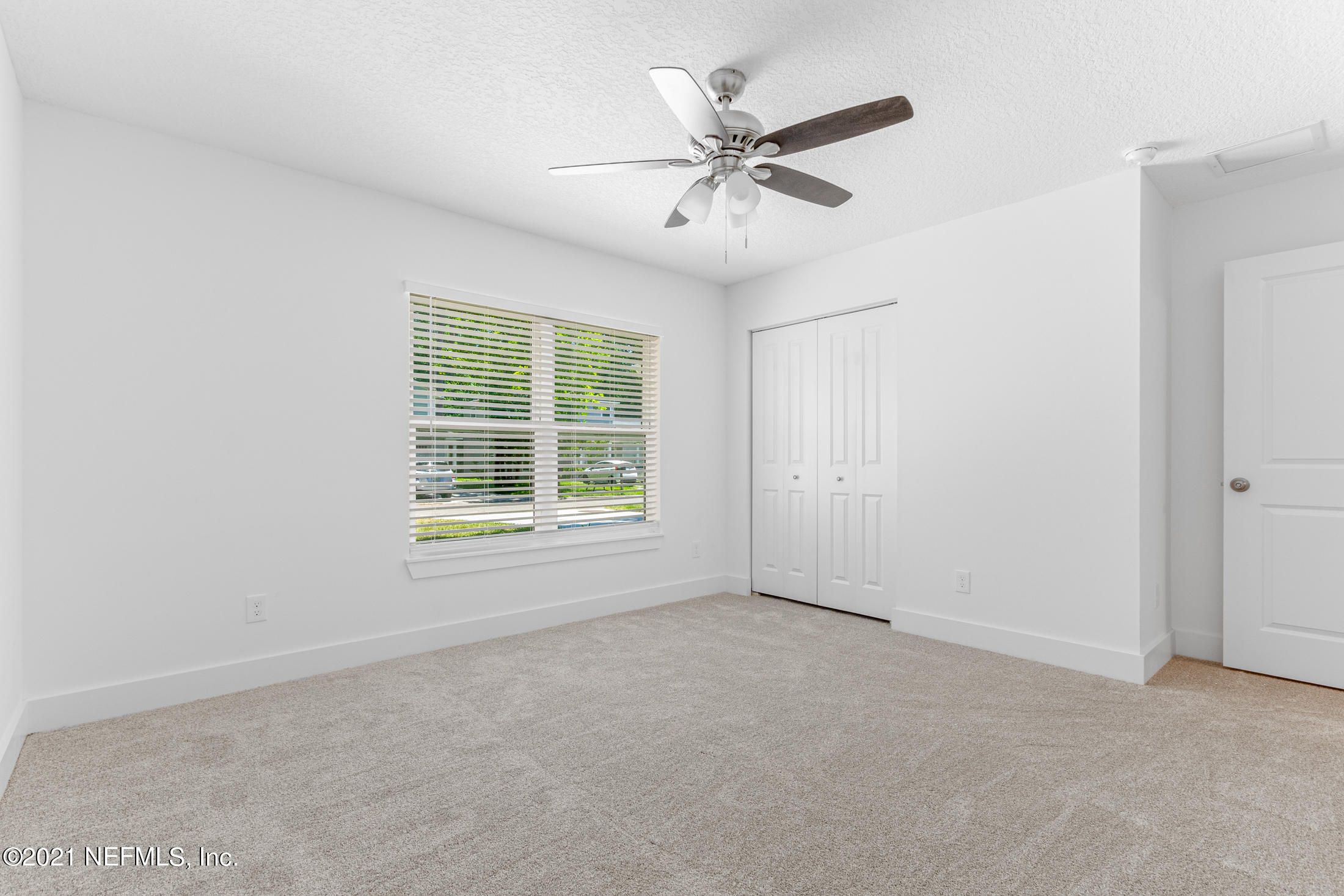 528 Meteor Street Jacksonville, FL 32205 - Photo 27 of 34 an empty room with windows and fan