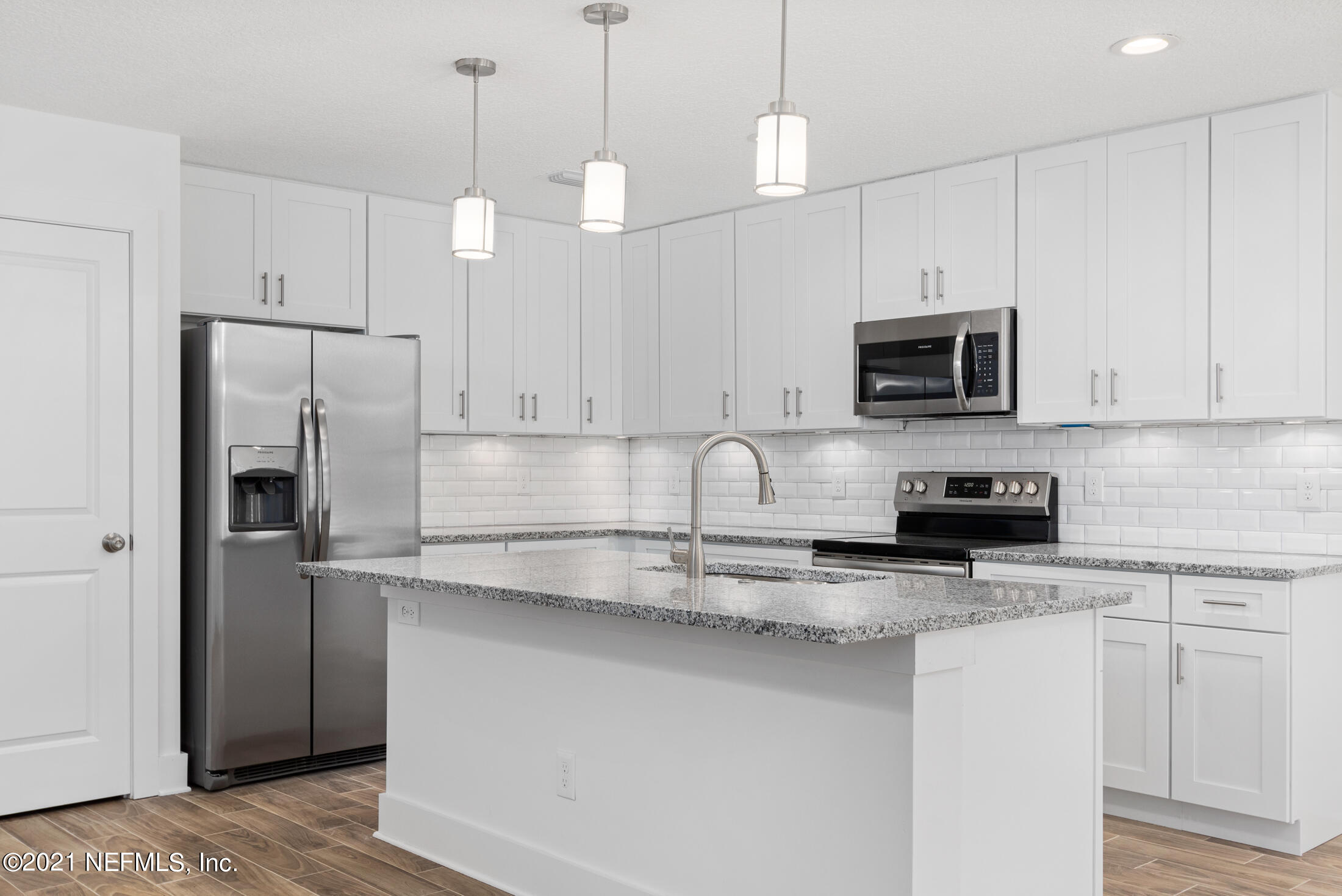528 Meteor Street Jacksonville, FL 32205 - Photo 9 of 34 a kitchen with kitchen island a white cabinets and stainless steel appliances