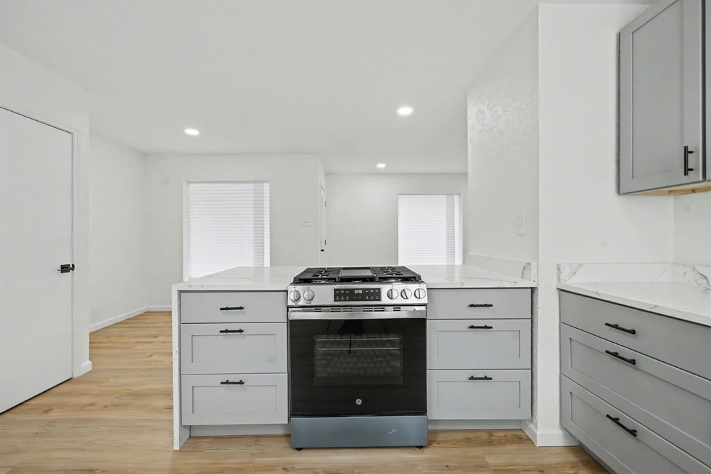 11446 Lippitt Avenue Dallas, TX 75218 - Photo 11 of 26 a kitchen with a stove and cabinets