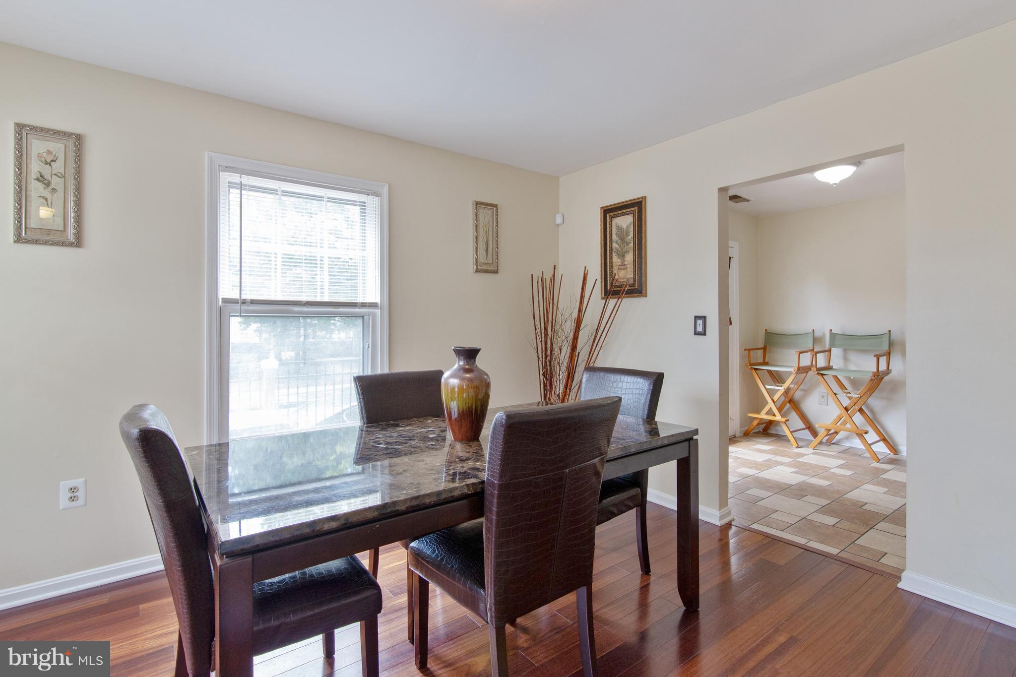 9304 Palmer Place, Unit 5 Laurel, MD 20708 - Photo 9 of 30 a view of a dining room with furniture window and wooden floor