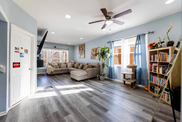 a living room with furniture and a book shelf