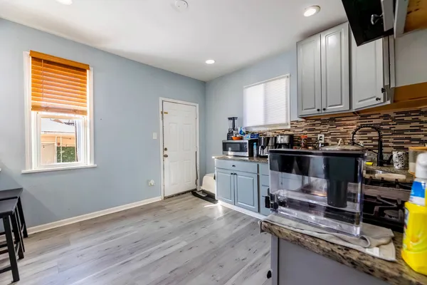 a kitchen with a sink and wooden cabinets