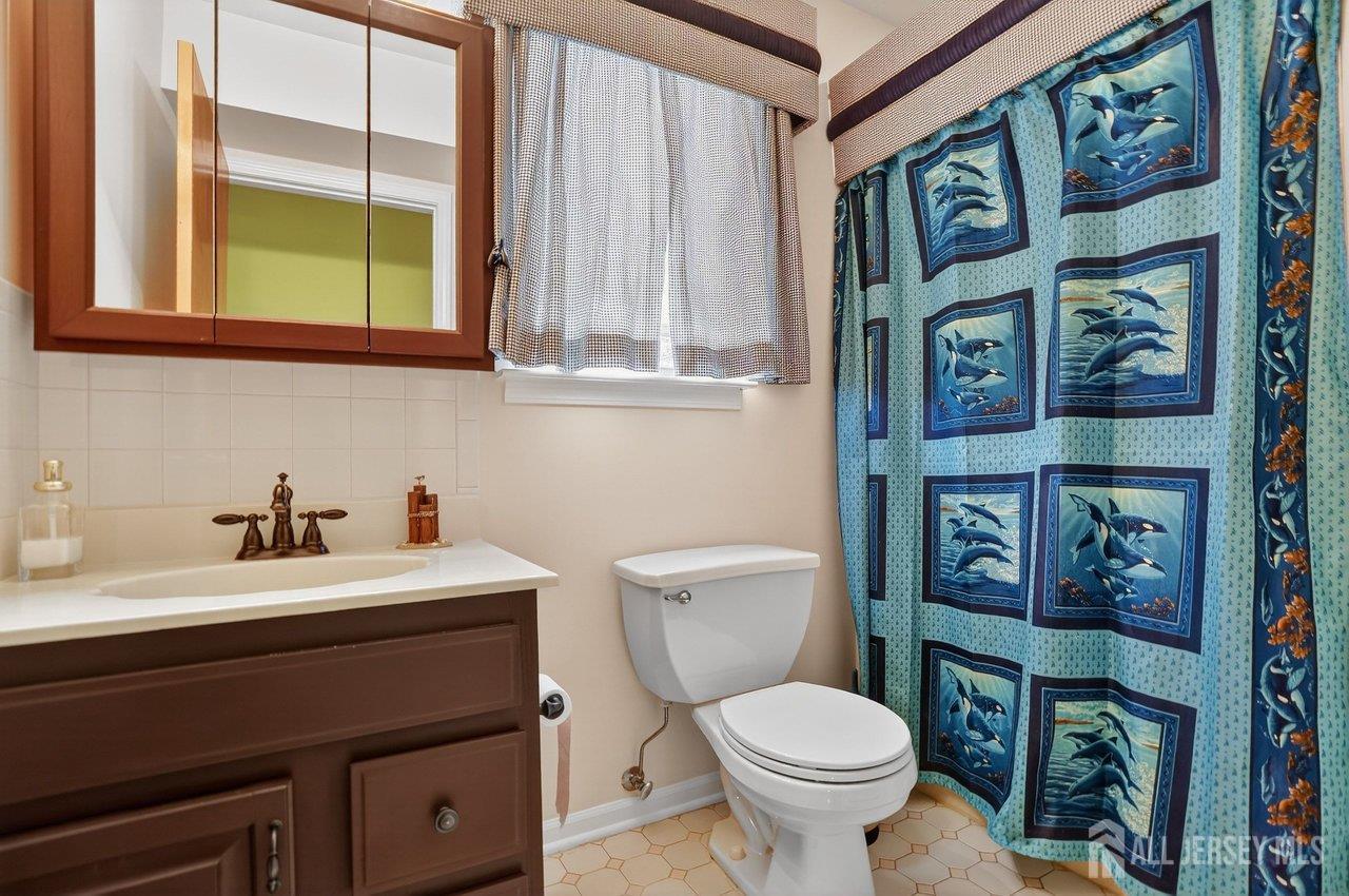 1 Wakefield Drive Edison, NJ 08820 - Photo 23 of 29 a bathroom with a toilet sink and mirror