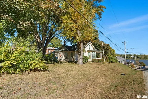 a view of a house with a tree in the background