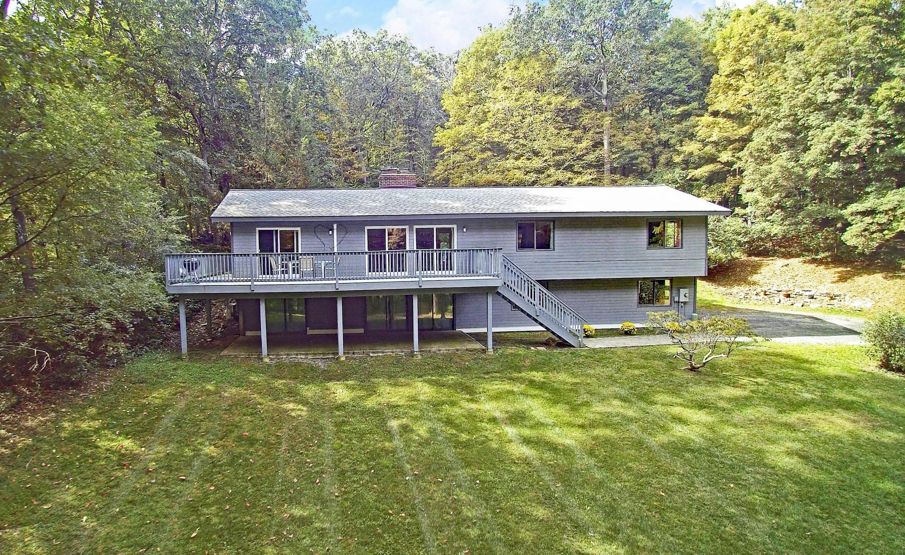 a view of a house with pool and a yard