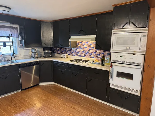 a kitchen with a sink stove and cabinets