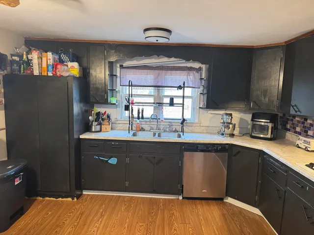 a kitchen with stainless steel appliances granite countertop a refrigerator and a sink