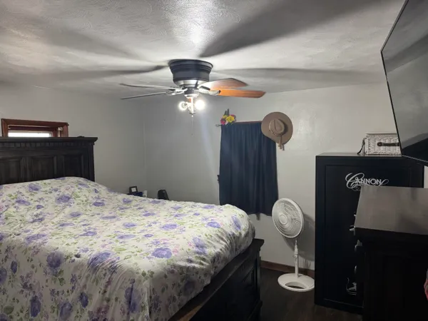 a bedroom with a bed and a chandelier