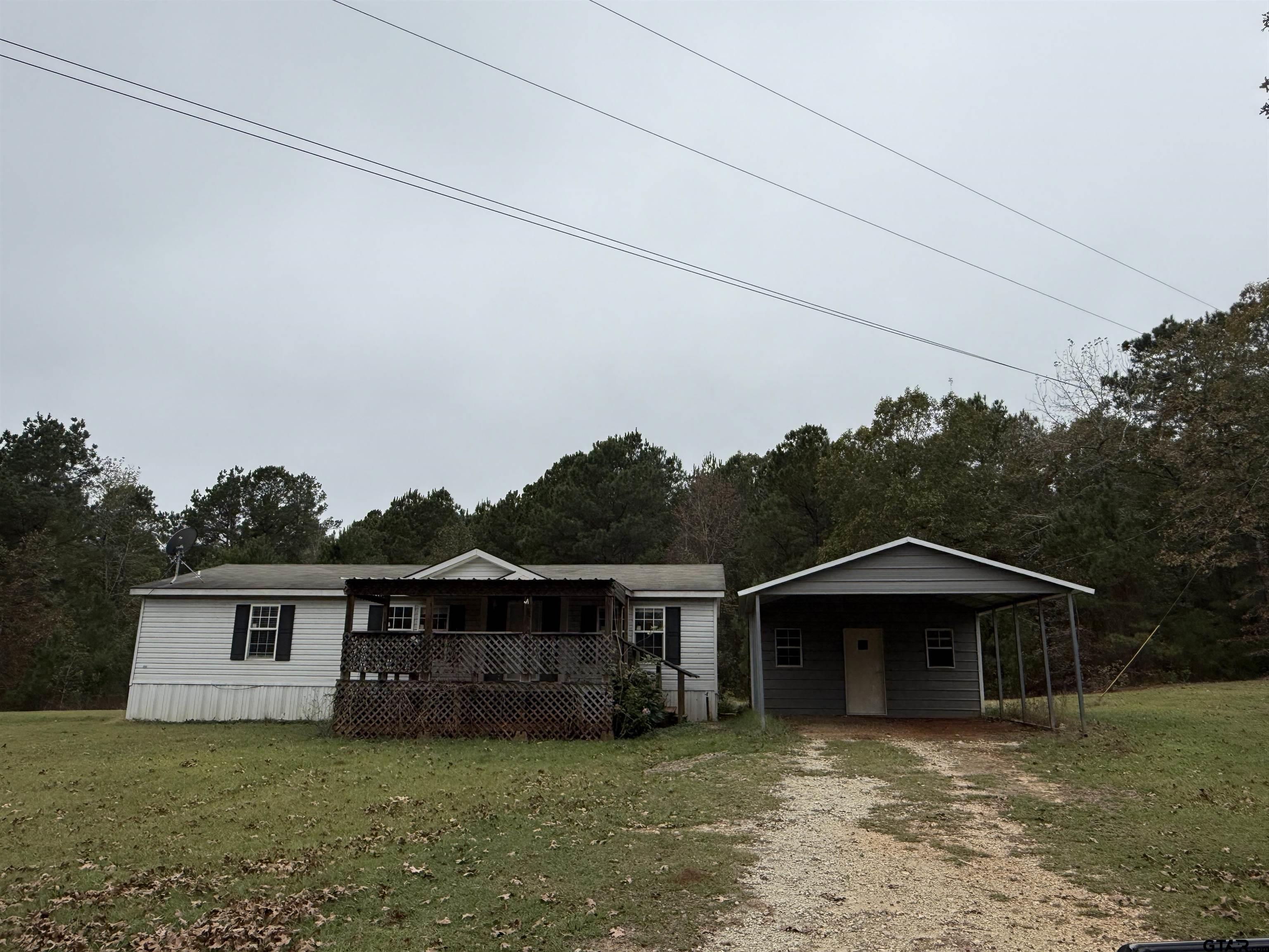 241 CR 2445 Rusk, TX 75785 - Photo 1 of 11 a view of a yard in front of a house with large trees