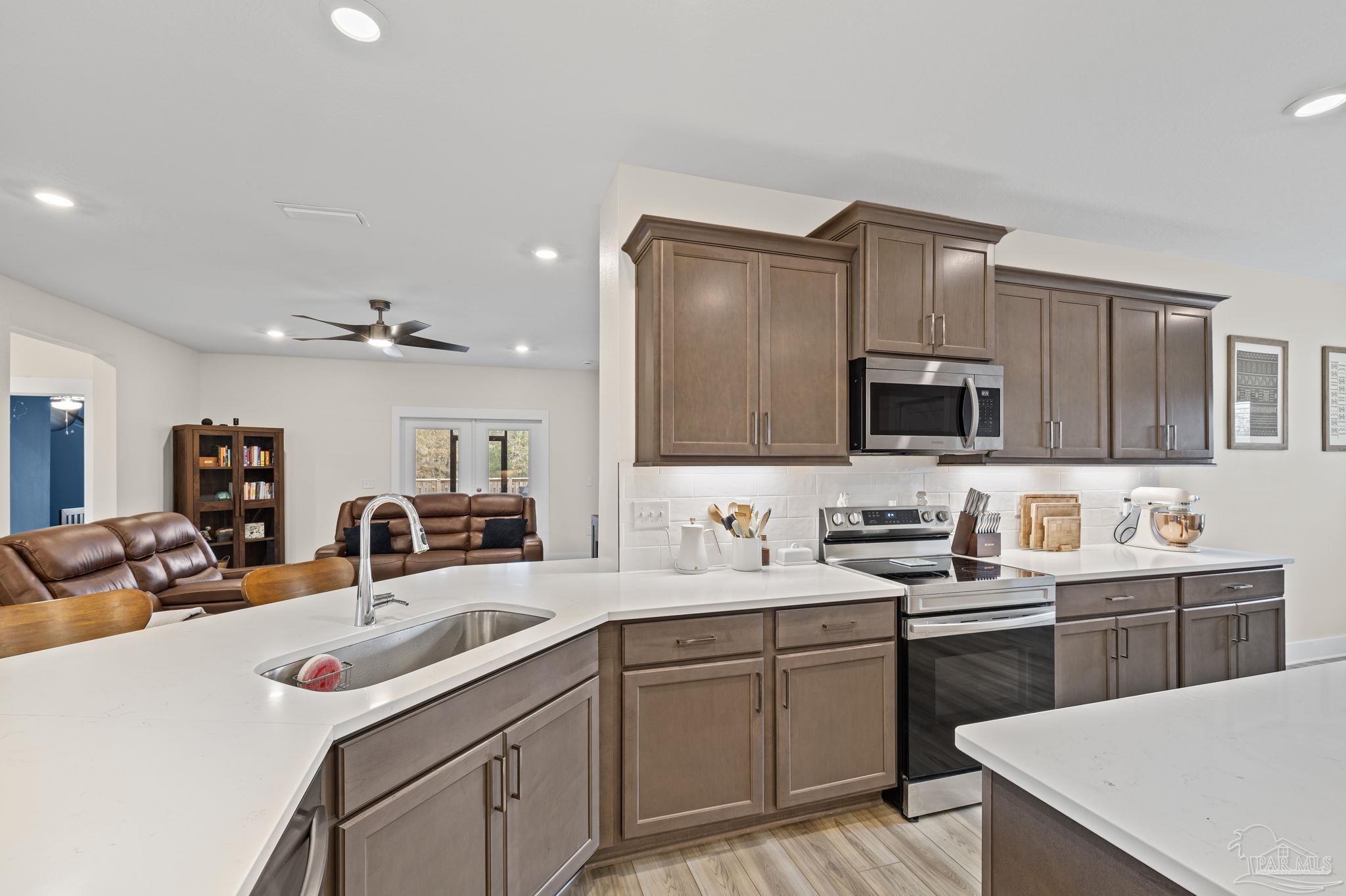 6266 Dry Creek Road Molino, FL 32577 - Photo 18 of 68 a kitchen with a sink stove and microwave