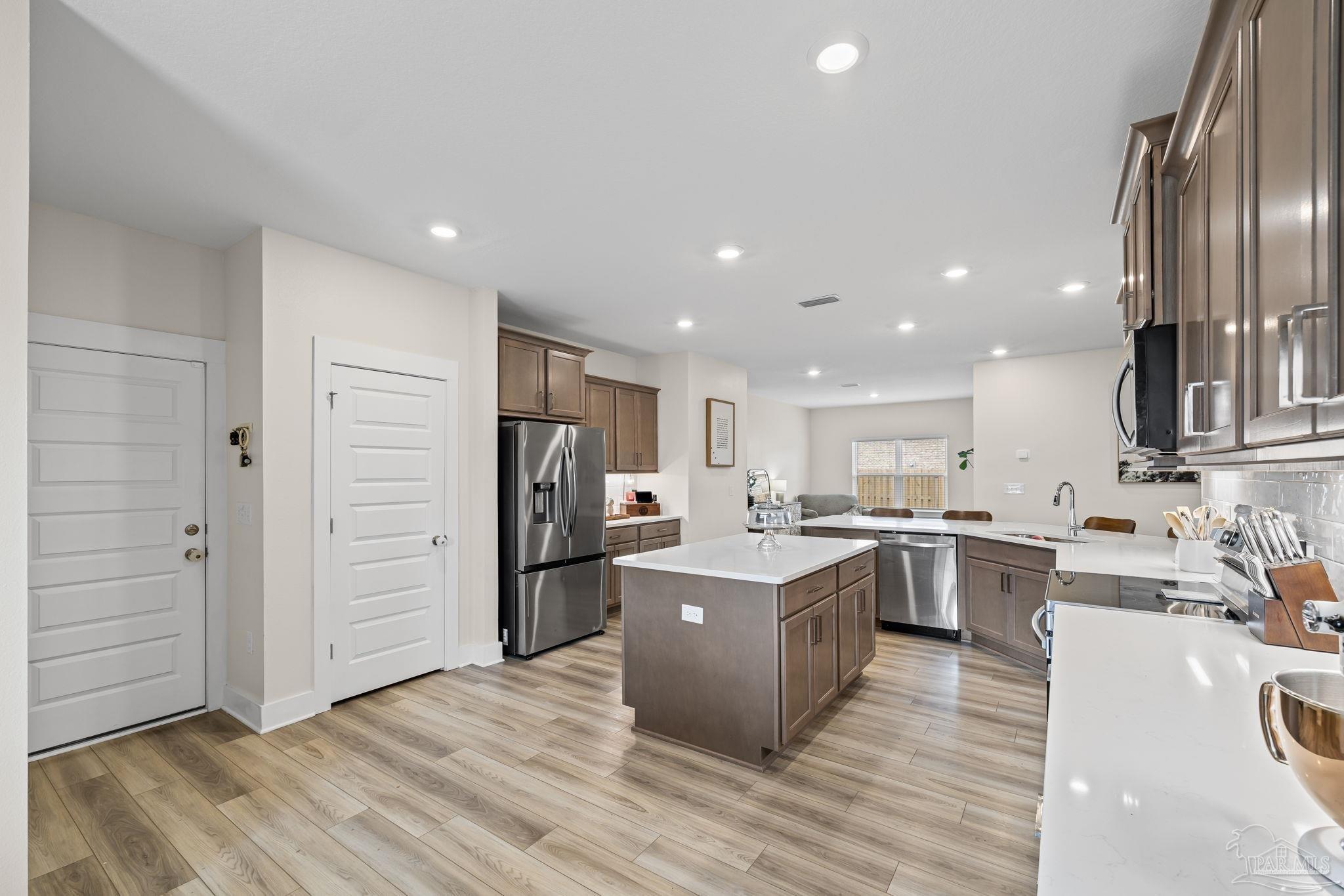 6266 Dry Creek Road Molino, FL 32577 - Photo 19 of 68 a kitchen with stainless steel appliances kitchen island granite countertop a refrigerator a stove top oven and sink