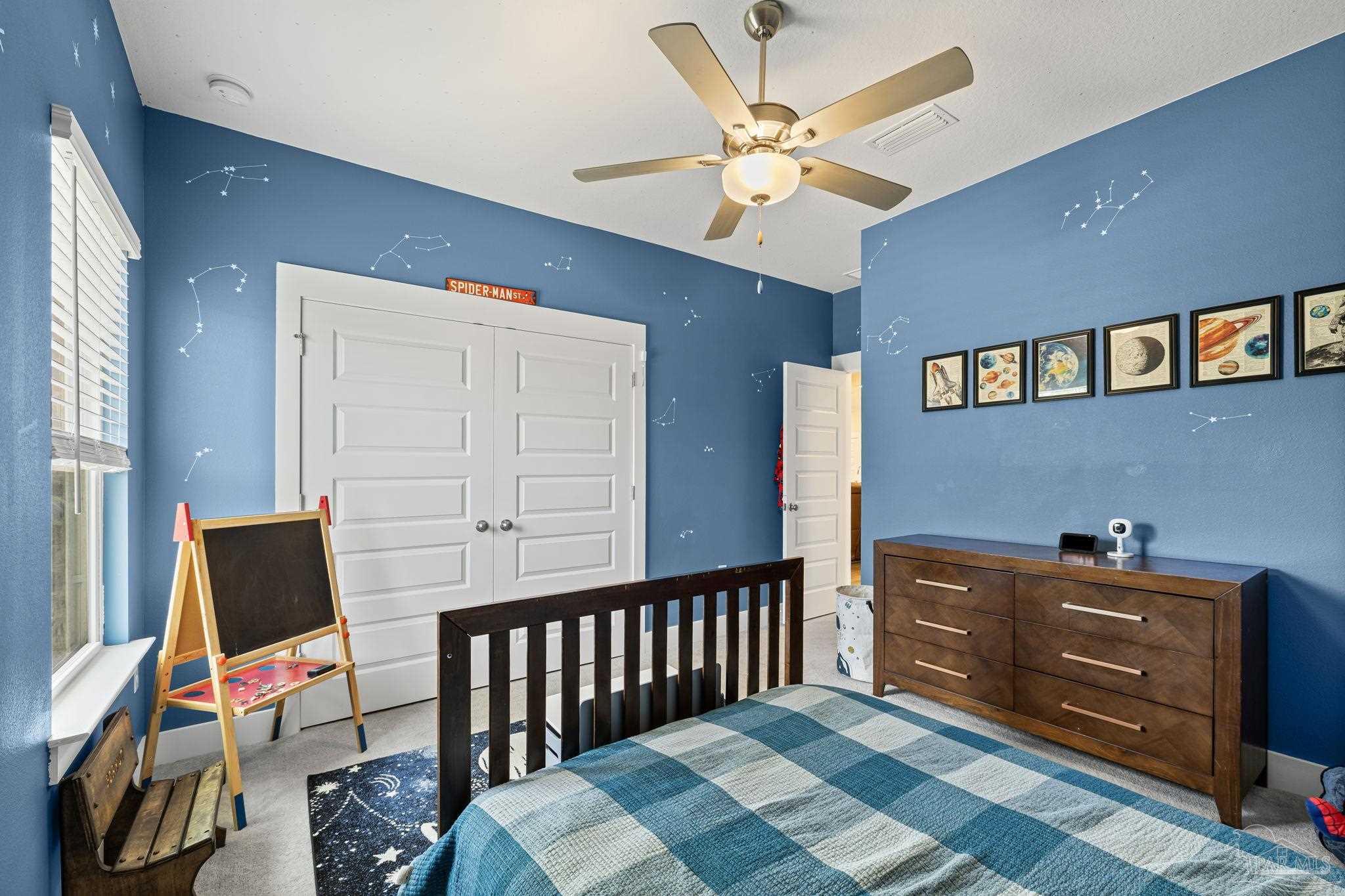 6266 Dry Creek Road Molino, FL 32577 - Photo 29 of 68 a bedroom with a bed and a chandelier