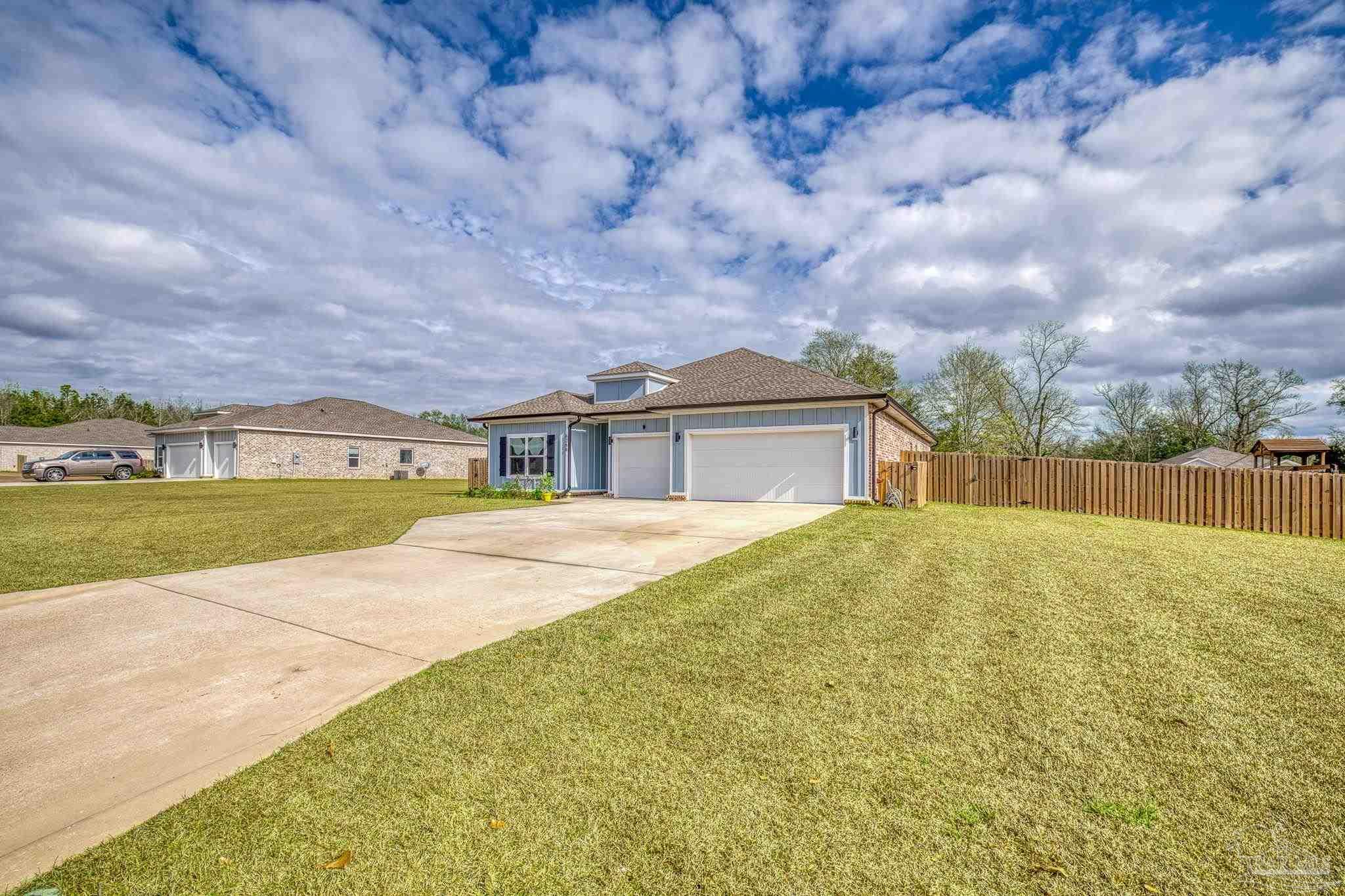 6266 Dry Creek Road Molino, FL 32577 - Photo 62 of 68 a front view of a house with a yard