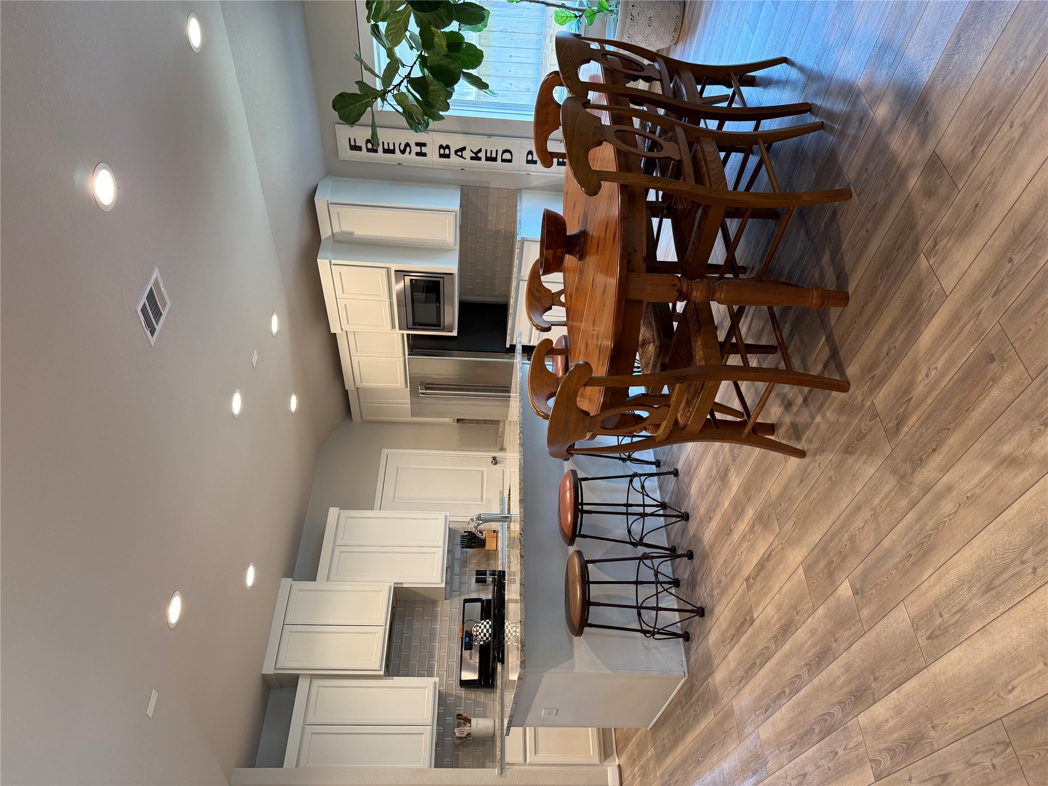 2336 Hagerman Road Conroe, TX 77384 - Photo 16 of 35 a view of a dining room with furniture and wooden floor