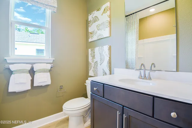 a bedroom with a bed a mirror and a window