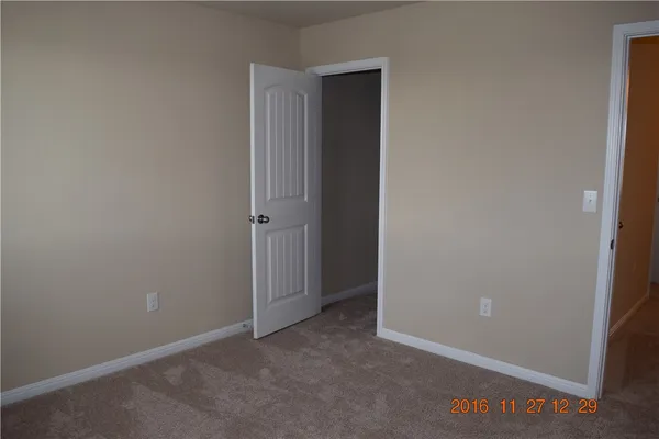 an empty room with closet area