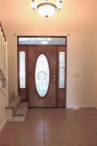 a view of a livingroom with wooden floor and a potted plant