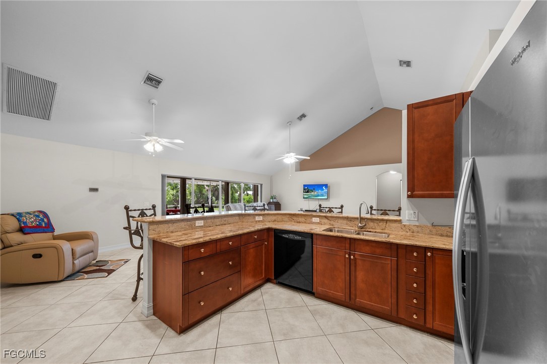 90 24th Avenue Northeast Naples, FL 34120 - Photo 13 of 50 a kitchen with a stove a sink and a refrigerator