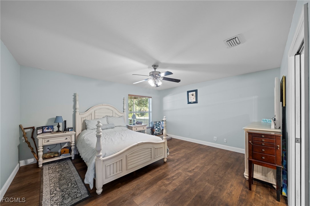 90 24th Avenue Northeast Naples, FL 34120 - Photo 15 of 44 a bedroom with a bed table and a window