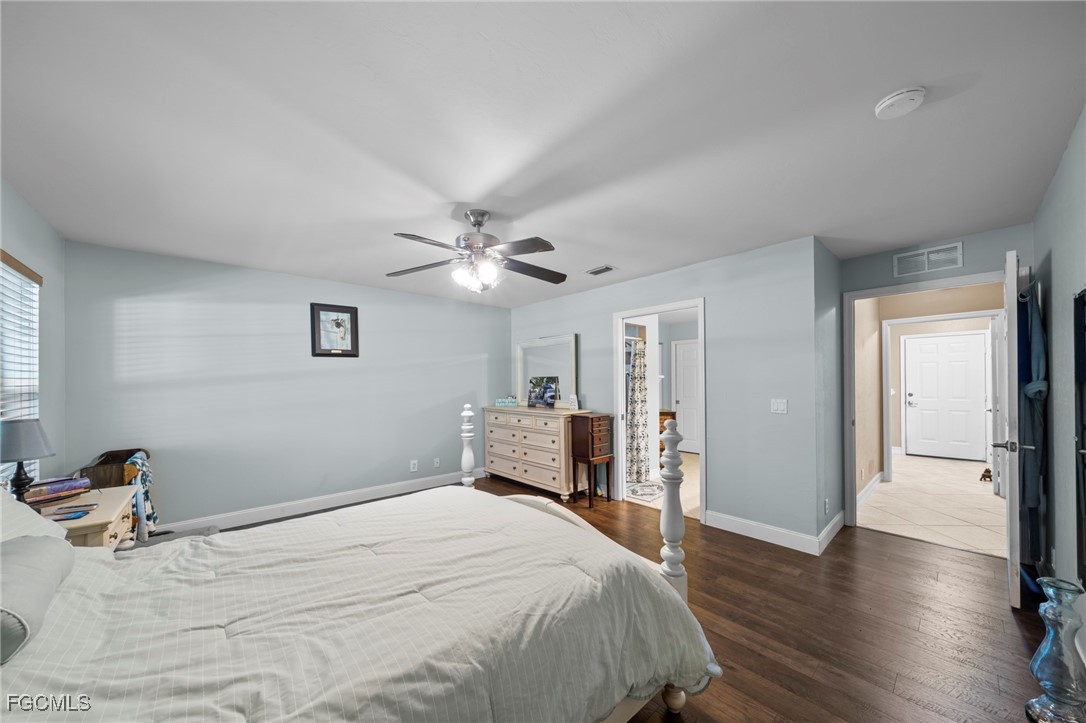 90 24th Avenue Northeast Naples, FL 34120 - Photo 16 of 44 a bedroom with a bed and wooden floor