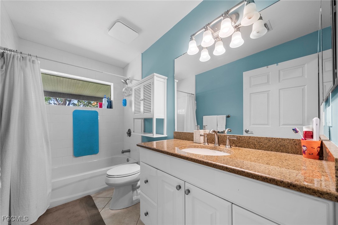 90 24th Avenue Northeast Naples, FL 34120 - Photo 19 of 44 a bathroom with a toilet a sink and a large mirror