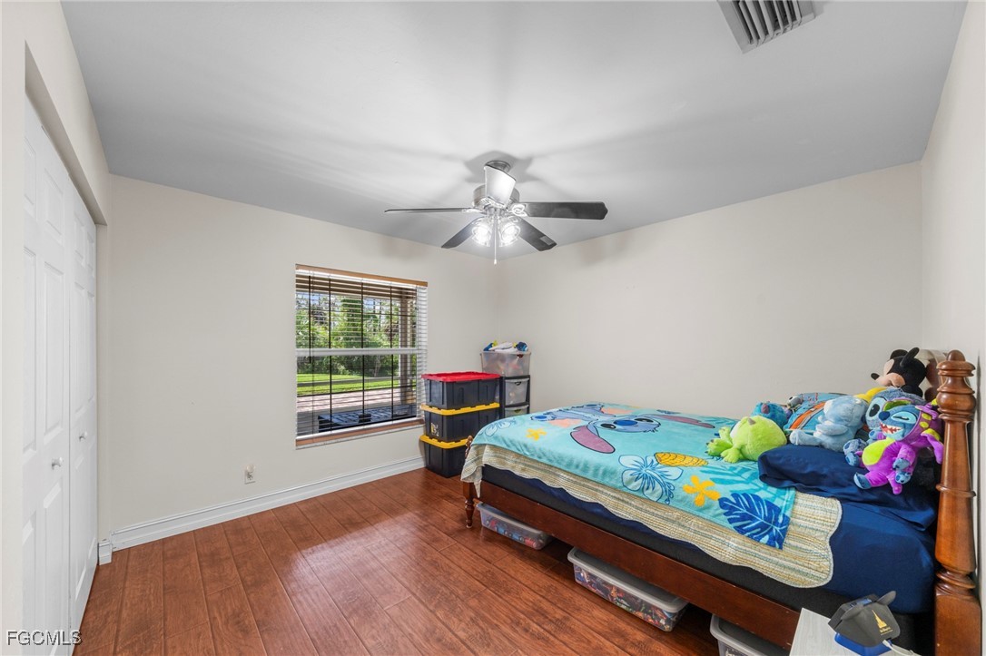 90 24th Avenue Northeast Naples, FL 34120 - Photo 20 of 44 a bedroom with a bed and a chandelier