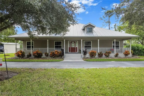 a view of a house with a patio and a yard