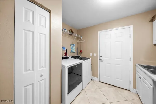 a front view of a house with garden and trees