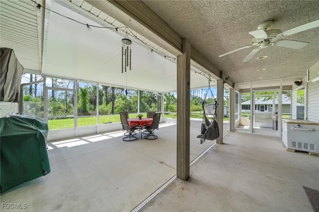 a view of a porch with furniture and garden